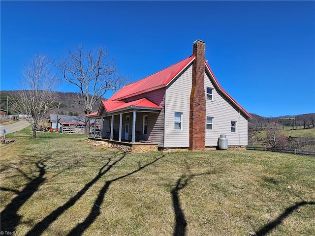 4793 Cheek Mountain Rd, Laurel Springs, NC 28644 - view of property exterior with covered porch, a chimney, a lawn, and metal roof