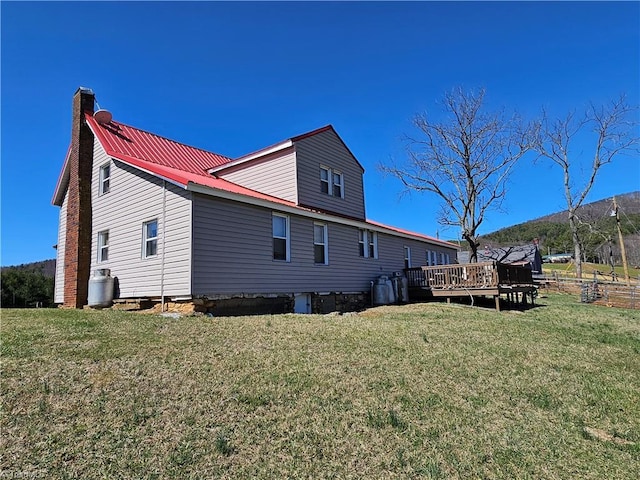 4793 Cheek Mountain Rd, Laurel Springs, NC 28644 - back of house featuring a wooden deck, a yard, metal roof, and a chimney