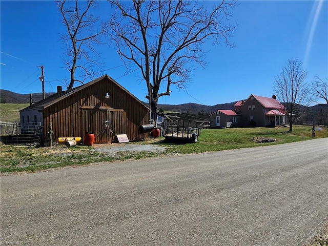 4793 Cheek Mountain Rd, Laurel Springs, NC 28644 - view of side of property featuring a mountain view, board and batten siding, and a lawn