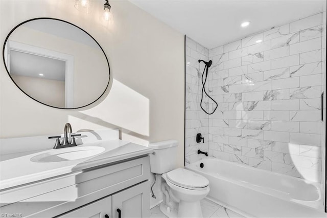 full bathroom with vanity, tiled shower / bath combo, and toilet