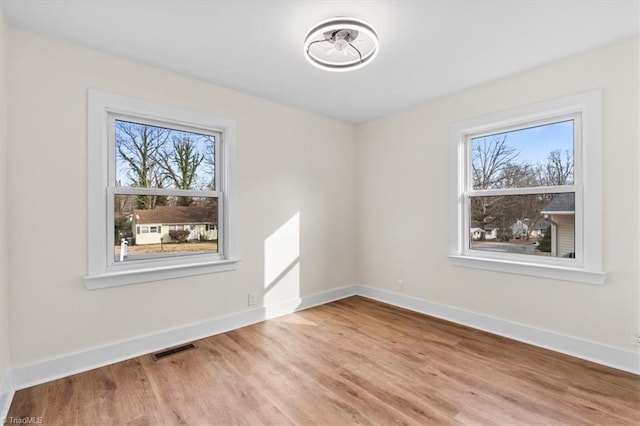 unfurnished room with hardwood / wood-style floors