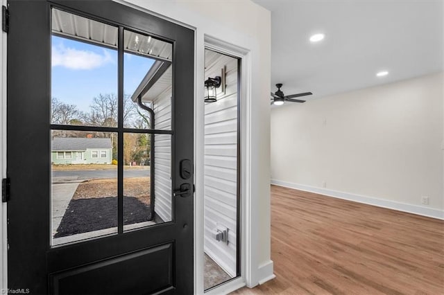 doorway featuring hardwood / wood-style flooring and ceiling fan