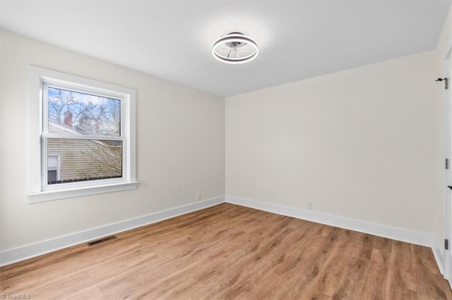 spare room with wood-type flooring