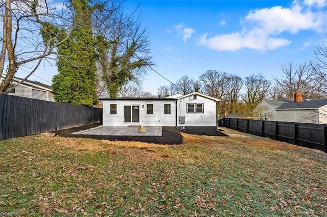 rear view of house featuring a lawn and a patio area