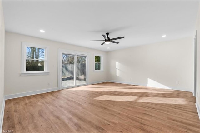 unfurnished room with ceiling fan and light wood-type flooring