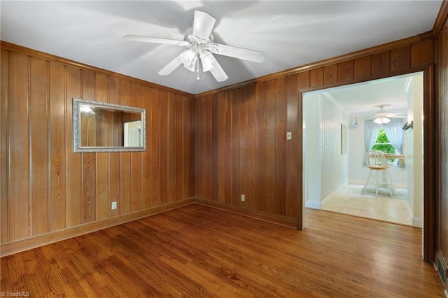 2505 Roland Rd, Greensboro, NC 27407 - spare room with a ceiling fan, wood finished floors, and wood walls