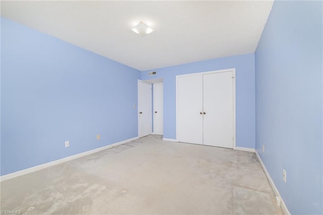 4330 Edith Ln Unit A, Greensboro, NC 27409 - unfurnished bedroom with light carpet, a closet, and baseboards