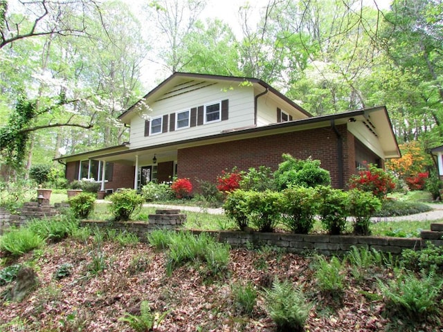 view of side of property with brick siding