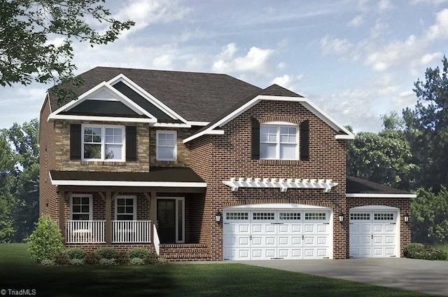 view of front of house with covered porch, a garage, and a front yard