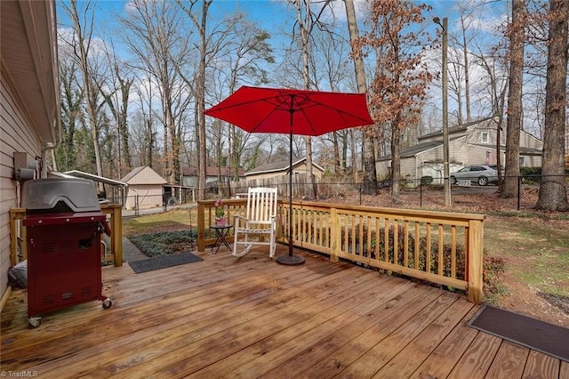 wooden deck with fence private yard and a grill