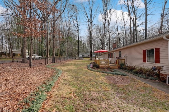 view of yard featuring a deck and fence