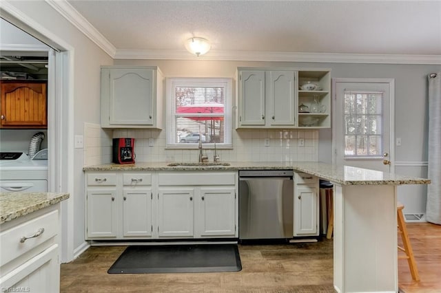 kitchen featuring a sink, crown molding, dark wood finished floors, and dishwasher