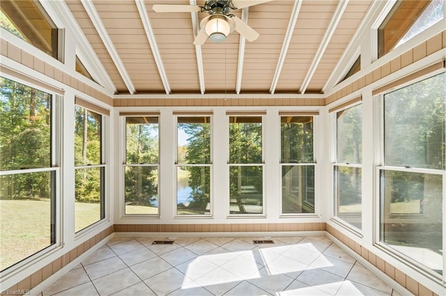 unfurnished sunroom with wood ceiling, a healthy amount of sunlight, and ceiling fan