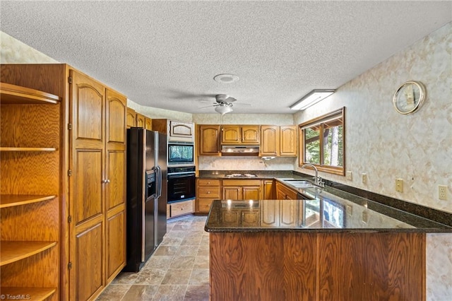 kitchen featuring kitchen peninsula, sink, black appliances, a textured ceiling, and ceiling fan