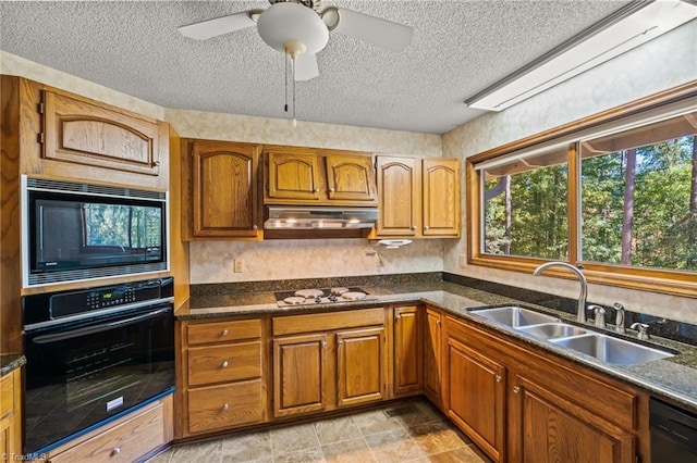 kitchen featuring ceiling fan, a textured ceiling, black appliances, and sink