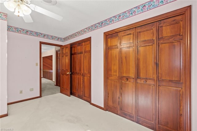 unfurnished bedroom featuring light carpet and ceiling fan