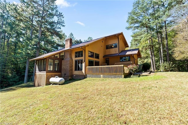 rear view of property featuring a lawn