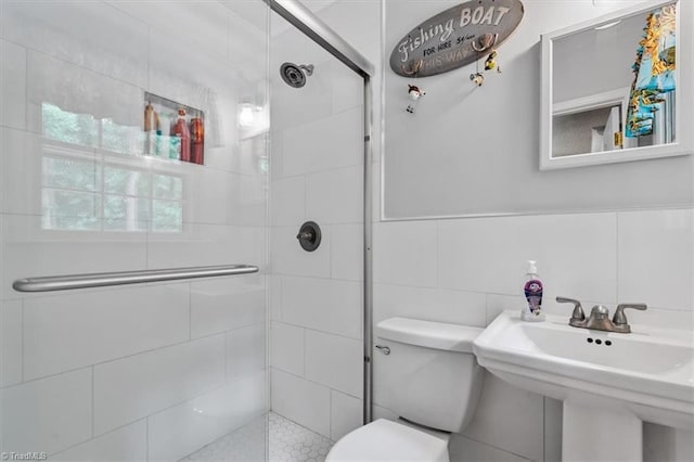 4515 Gilmore Dr, Liberty, NC 27298 - bathroom with a stall shower, toilet, tile walls, and a sink