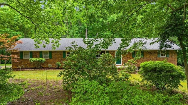 4515 Gilmore Dr, Liberty, NC 27298 - single story home featuring brick siding, a front yard, and a shingled roof