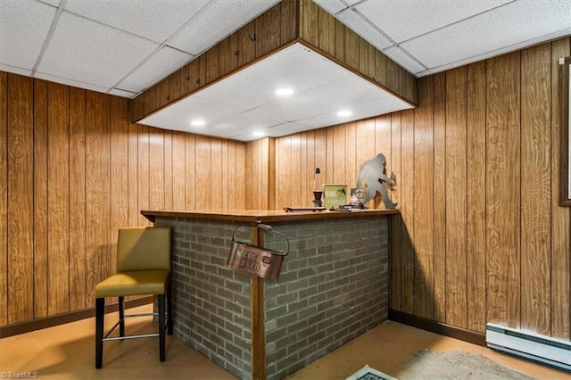 4515 Gilmore Dr, Liberty, NC 27298 - indoor dry bar featuring a baseboard radiator, a drop ceiling, wooden walls, and concrete floors