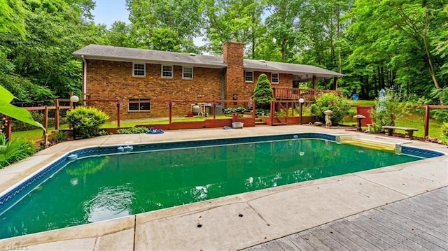 4515 Gilmore Dr, Liberty, NC 27298 - swimming pool featuring a deck and view of scattered trees