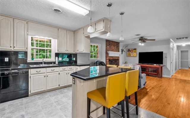 4515 Gilmore Dr, Liberty, NC 27298 - kitchen featuring black dishwasher, a sink, ceiling fan, dark countertops, and a textured ceiling