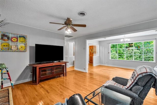 4515 Gilmore Dr, Liberty, NC 27298 - living area with wood finished floors, crown molding, ceiling fan, a textured ceiling, and a chandelier