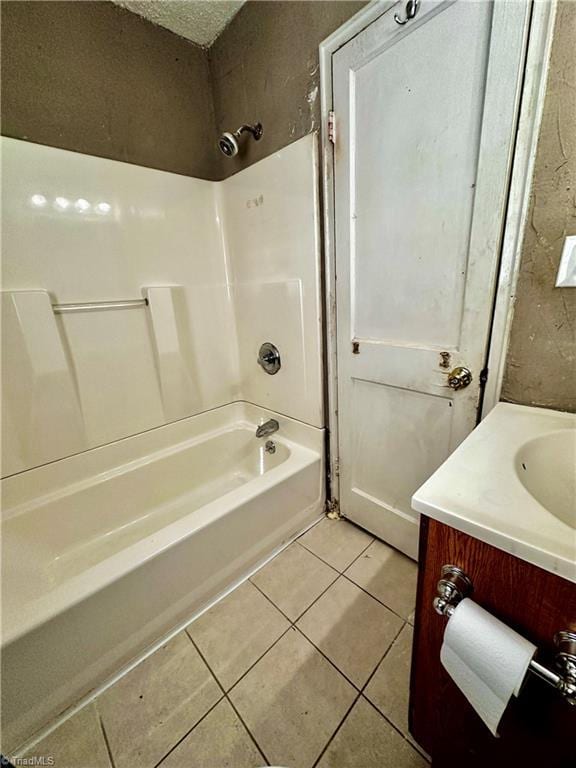 bathroom with tile patterned flooring, vanity, and tub / shower combination