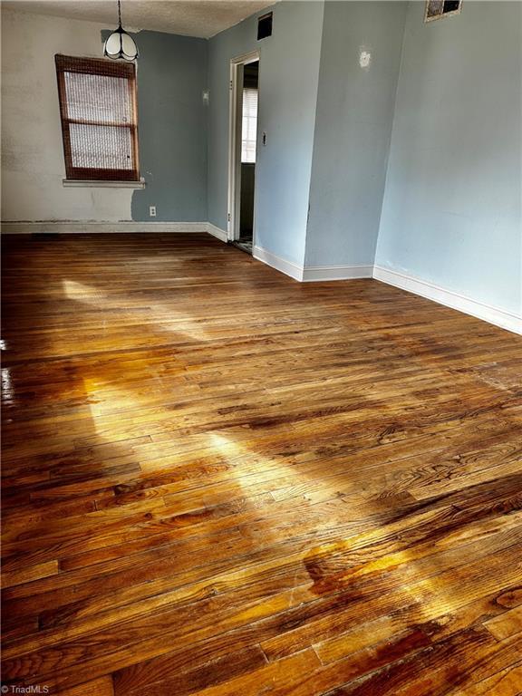 empty room with wood-type flooring