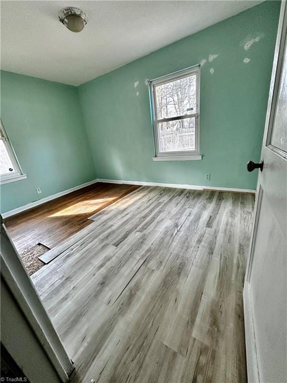 empty room with light hardwood / wood-style floors