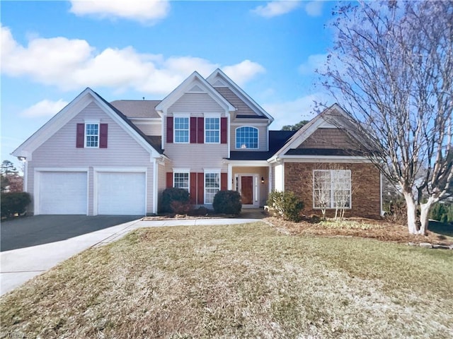 view of front of property featuring a garage and a front lawn