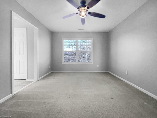 spare room with light carpet and ceiling fan