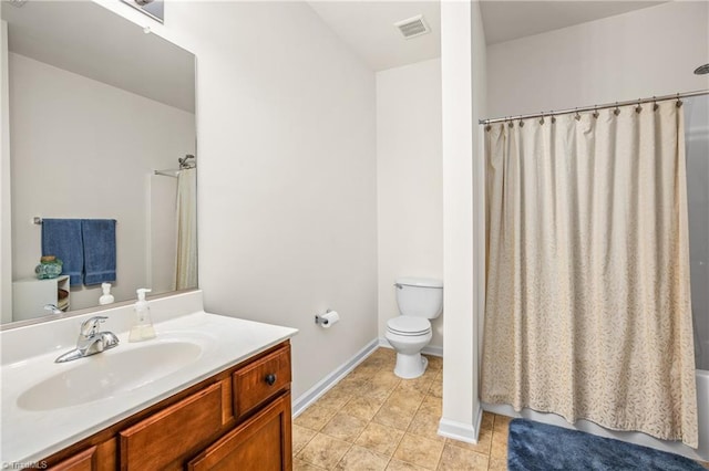 bathroom featuring tile patterned flooring, vanity, and toilet