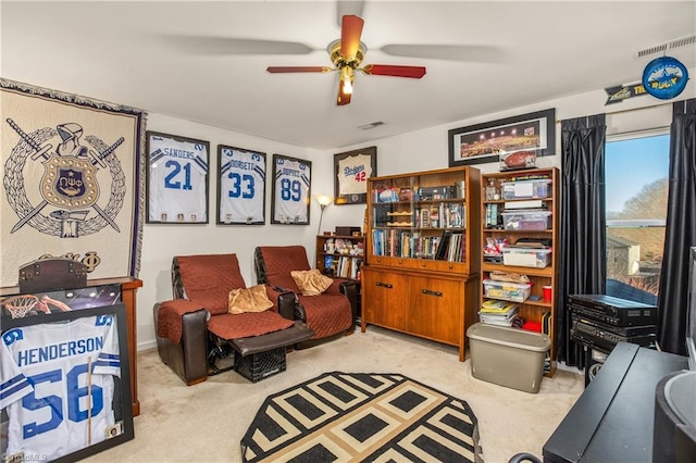 sitting room featuring ceiling fan and light carpet