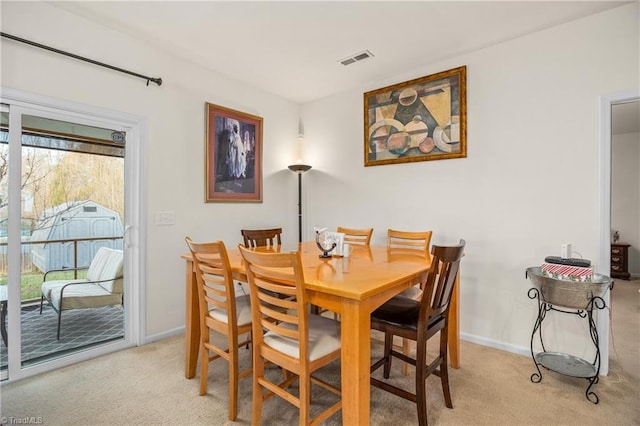 dining room with light colored carpet