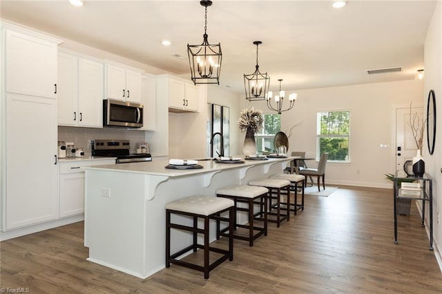 6021 Crestridge Ln Unit 1003, Winston-Salem, NC 27105 - kitchen with appliances with stainless steel finishes, a chandelier, a large island, white cabinetry, and recessed lighting