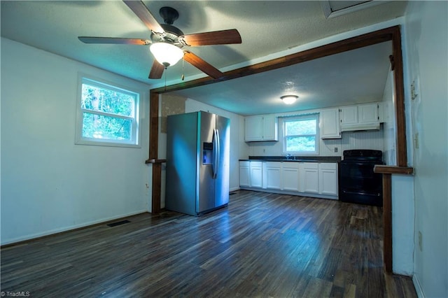 1176 Arbor Grove Church Rd, Millers Creek, NC 28697 - kitchen with black electric range, stainless steel fridge, dark countertops, dark wood-style floors, and white cabinets