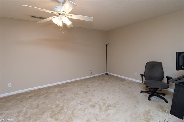 unfurnished office with carpet flooring, baseboards, visible vents, and ceiling fan