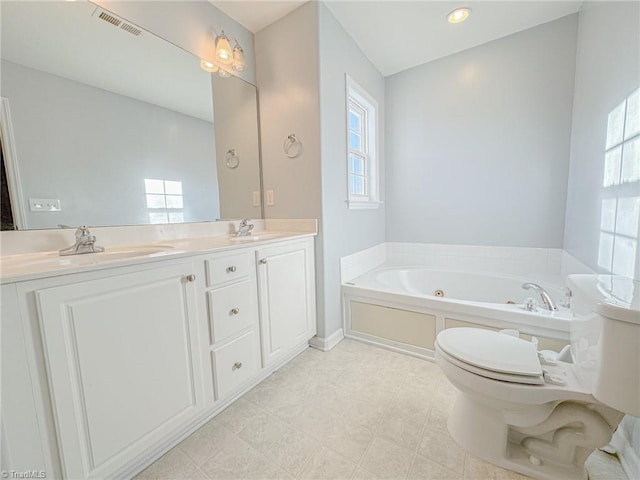 bathroom featuring visible vents, a sink, a jetted tub, and double vanity