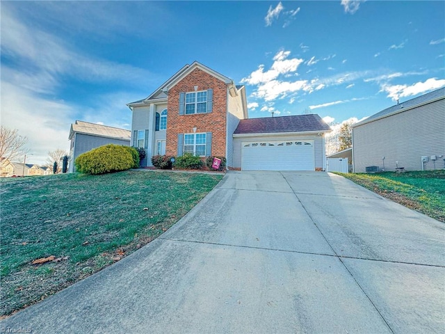 traditional-style home with a garage, driveway, brick siding, and a front yard