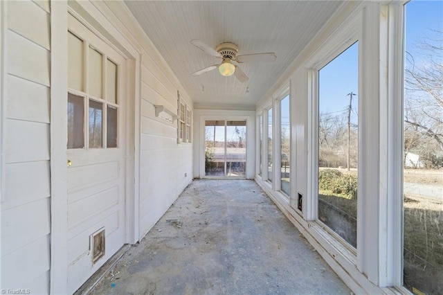 unfurnished sunroom featuring ceiling fan