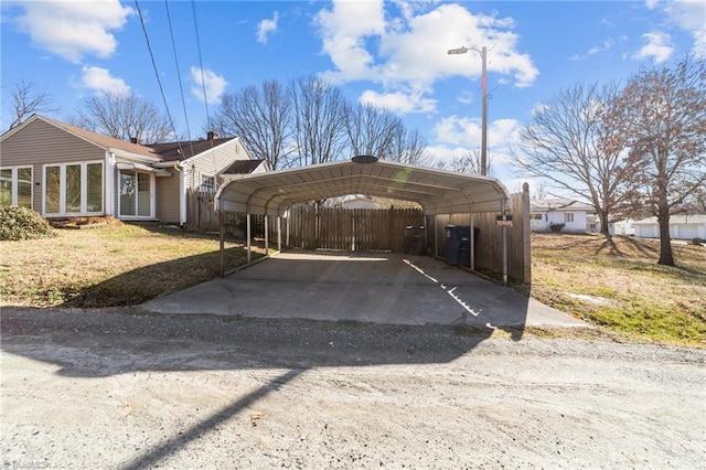 view of parking featuring a yard and a carport