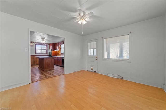 unfurnished living room with light hardwood / wood-style flooring and ceiling fan