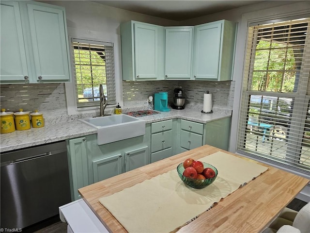 kitchen featuring dishwasher, green cabinetry, a wealth of natural light, and sink