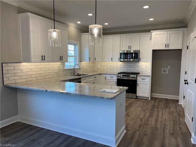 kitchen with white cabinets, decorative light fixtures, a peninsula, stainless steel appliances, and a sink