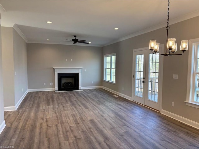 unfurnished living room featuring dark wood-style floors, baseboards, a fireplace, and crown molding