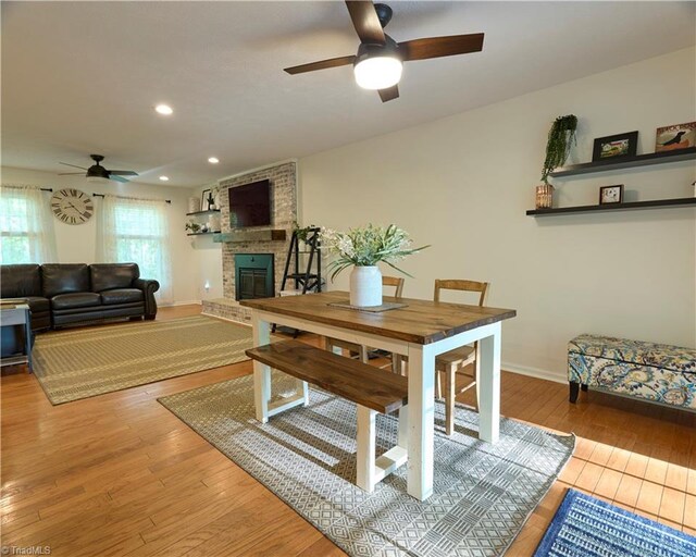 6130 Narrow Way Ln, Winston-Salem, NC 27105 - dining area featuring a ceiling fan, a fireplace, light wood finished floors, baseboards, and recessed lighting