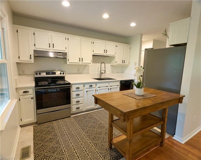 6130 Narrow Way Ln, Winston-Salem, NC 27105 - kitchen with appliances with stainless steel finishes, a sink, under cabinet range hood, white cabinets, and recessed lighting