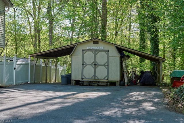 6130 Narrow Way Ln, Winston-Salem, NC 27105 - view of shed featuring driveway, a carport, and fence