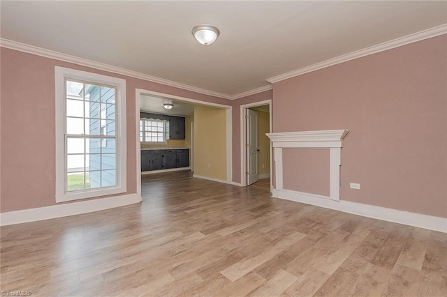 unfurnished living room featuring crown molding and light hardwood / wood-style flooring